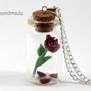Rose with fallen petals in a glass jar necklace